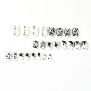 Anime style black and white press-on nail kit with abstract swirl and ink splash designs