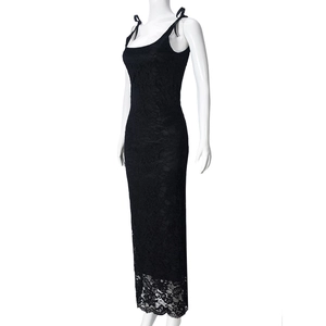 Detail of black lace maxi dress featuring intricate floral patterns and scalloped hemline