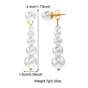 Detailed view of pearl drop earrings with gold finish and measurements 4.4cm by 1.0cm