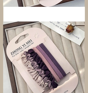 Set lila Scrunchies und elastische Haarbänder aus Stoff auf elegantem Display
