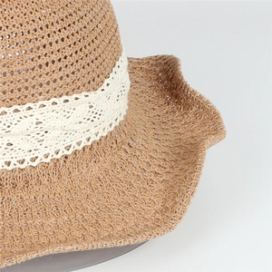 Détail macro de la texture du chapeau de paille avec bordure en dentelle blanche élégante