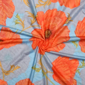 Detailed view of sheer mesh fabric featuring orange floral print on a blue background