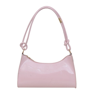 Pink patent leather underarm shoulder bag with decorative knotted strap and glossy finish