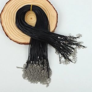 Detail of bulk black waxed necklace cords with silver lobster clasps and extension chains