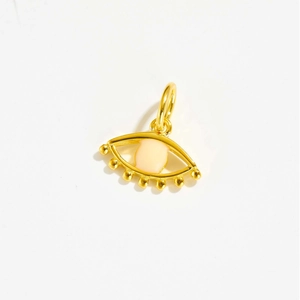 Detail shot of golden evil eye pendant with pink enamel and micro-set zircon