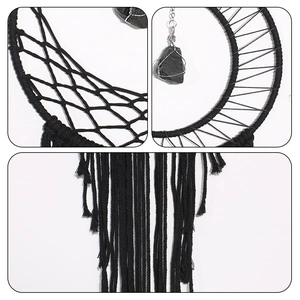 Detailed view of black macrame dreamcatcher with moon design, crystal, and cotton tassels