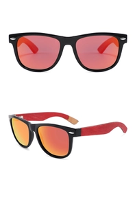 Detail of oval frame sunglasses with red mirrored lenses and red wood texture temples