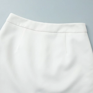 Close-up of white woven skirt waistline detailing with professional dart stitching design