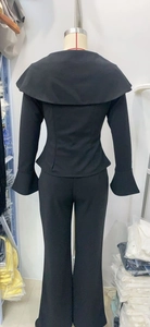 Rear view of black flare sleeve top and trousers set showing back collar detail on mannequin