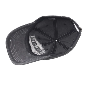 Detail view of cotton baseball cap interior showing stitching and 100% cotton label