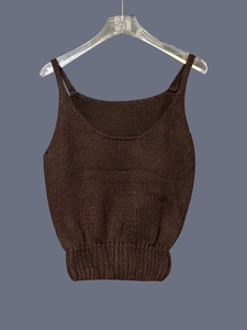 Detailed close-up of dark brown knitted tank top featuring wide U-neck and ribbed hemline