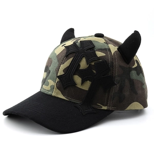 Camo devil horn baseball cap with pink cross patch and gothic punk aesthetic