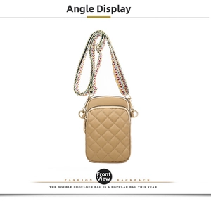 Detail of khaki quilted crossbody bag featuring a colorful geometric woven strap and zipper