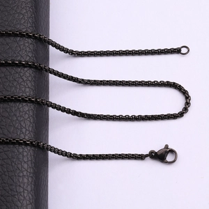 Detail of a titanium steel box chain necklace with a black finish and lobster clasp closure