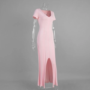 Close-up of pink V-neck knitted maxi dress with a slim waist and side slit detail