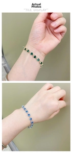 Detail showing heart-shaped emerald and sapphire zircon bracelets with claw settings