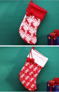 Detailed knit Christmas stockings with reindeer and snowflake patterns and pom-poms