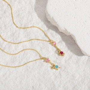Gold layering necklaces featuring pink heart and star pendants with zircon stone accents