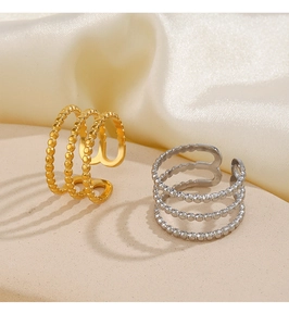 Detail of adjustable three-layer beaded stainless steel rings in gold and silver finish