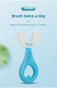 Detail of blue U-shaped kids toothbrush with silicone bristles and heart-shaped handle