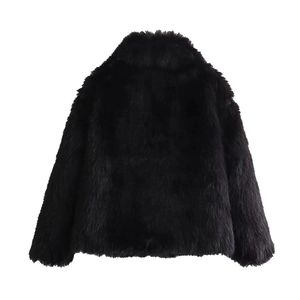 Detail view of the black faux fur texture on the back of this long-sleeved plush coat