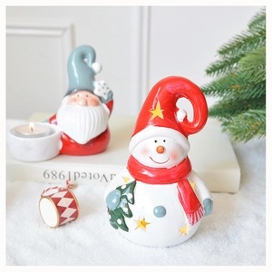 Detail showing ceramic Santa and snowman figurines with hollow stars for holiday decor
