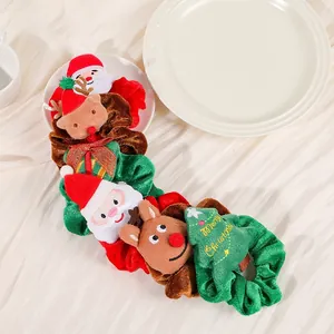 Detail of Christmas plush hair scrunchies with Santa, reindeer and tree embroidery