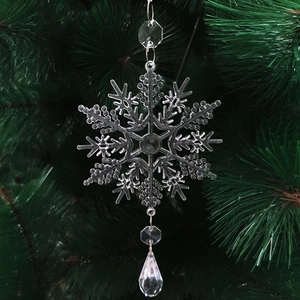 Detailed view of clear snowflake ornament with crystal beads on a Christmas tree