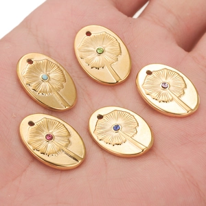 Bohemian oval floral pendant in gold finish with colorful rhinestones on hand