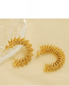 Macro detail of 18K gold plated C-shaped spiral earrings showing lead and nickel free quality