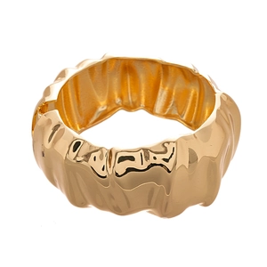 Minimalist wide gold cuff bracelet featuring a textured crumpled metal lava design