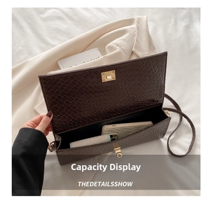 Detail view of the brown embossed leather handbag showing interior storage for a phone
