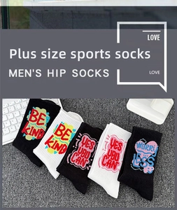 Detail of plus size sports socks in black and white featuring motivational slogans
