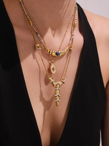 Detailed view of layered 18k gold plated necklaces with blue kyanite moon and star pendants