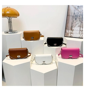 Detailed view of colorful mini crossbody bags with silver twist locks and chain straps