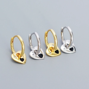 Detailed view of silver heart earrings with black enamel and sparkling zircons