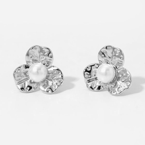 Detail of flower pearl stud earrings with textured silver petals and round pearls
