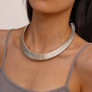Close-up of silver-tone wide choker necklace featuring vertical textured metallic stripes