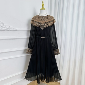 Elegant black long-sleeved pleated dress with luxury gold embroidery on the neck and cuffs