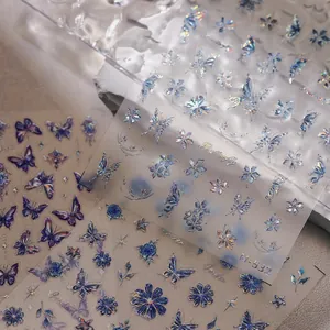 Detailed holographic butterfly nail art stickers with iridescent floral and star patterns