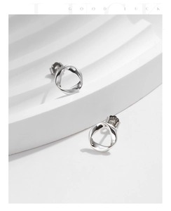 Detailed view of S925 sterling silver twist stud earrings with polished wave design