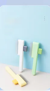 Detail showing self-cleaning pet brush set with ergonomic handles and massage pins