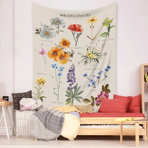 Detail of bohemian wildflower botanical tapestry hanging in a cozy bedroom wall setting