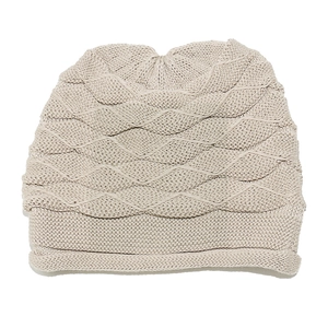 Detail of light beige knit beanie featuring textured 3D wave patterns for winter warmth