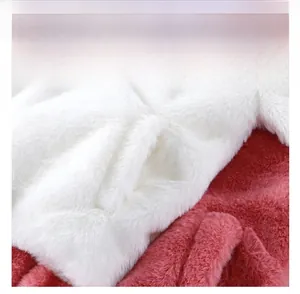 Close-up of fluffy faux rabbit fur jacket featuring a pink side pocket and white plush fabric