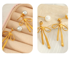 Detailed close-up of golden bow-shaped pearl earrings on stone and velvet background