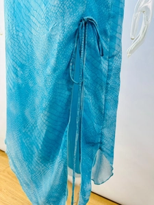 Detail of blue snake print chiffon dress featuring a side slit with drawstring tie