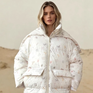 White puffer jacket with butterfly floral prints worn by a model in a desert landscape