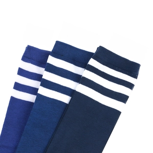 Flat lay of royal and navy blue knee-high socks with three white athletic stripes