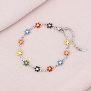 Detail of colorful enamel flower charms on a durable stainless steel chain link bracelet